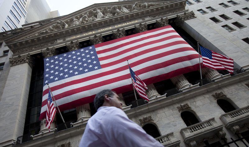In this Aug. 8, 2011 file photo, a pedestrian walks past the New York Stock Exchange in New York. (AP Photo/Jin Lee, File)