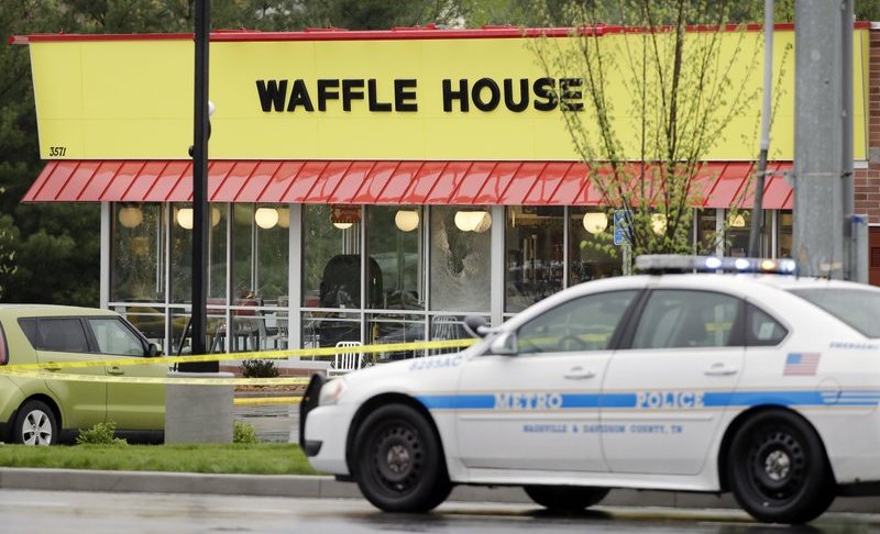 A police car sits in front of a Waffle House restaurant Sunday, April 22, 2018, in Nashville, Tenn. At least four people died after a gunman opened fire at the restaurant early Sunday. (AP Photo/Mark Humphrey)
