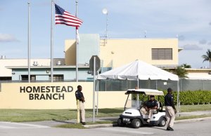 FILE: Security guards stand outside a former Job Corps site that now houses child immigrants, Monday, June 18, 2018, in Homestead, Fla. It is not known if the children crossed the border as unaccompanied minors or were separated from family members. An unapologetic President Donald Trump defended his administration’s border-protection policies Monday in the face of rising national outrage over the forced separation of migrant children from their parents. (AP Photo/Wilfredo Lee/FILE)