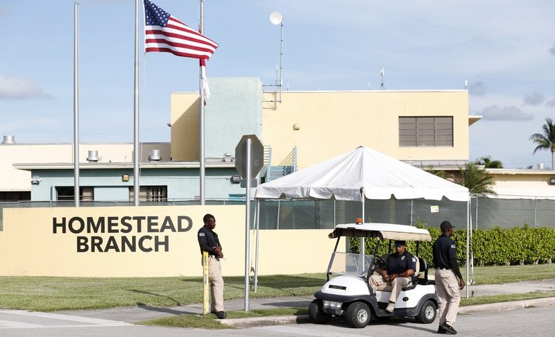 FILE: Security guards stand outside a former Job Corps site that now houses child immigrants, Monday, June 18, 2018, in Homestead, Fla. It is not known if the children crossed the border as unaccompanied minors or were separated from family members. An unapologetic President Donald Trump defended his administration’s border-protection policies Monday in the face of rising national outrage over the forced separation of migrant children from their parents. (AP Photo/Wilfredo Lee/FILE)