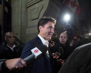 FILE: Prime Minister Justin Trudeau leaves the Office of the Prime Minister and Privy Council after an agreement was reached in the NAFTA negotiations in Ottawa, Ontario, Sunday, Sept. 30, 2018. The U.S. and Canada reached the basis of a free trade deal Sunday night, a senior Canadian government official said. (Justin Tang/The Canadian Press via AP/FILE)