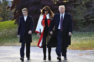 President Donald Trump with first lady Melania Trump and their son Barron Trump leave the White House Oval Office to travel to Mar-a-Lago in Florida. (AP photo)