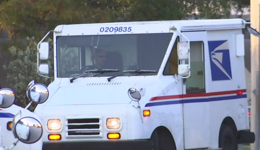 Several U.S. Postal Service vehicles. Photo via WINK News.