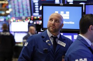 FILE: Specialist John Parisi watches the numbers near the close of trading on the floor of the New York Stock Exchange, Thursday, Dec. 27, 2018. U.S. stocks staged a furious late-afternoon rally Thursday, closing with gains after erasing a 600-point drop in the Dow Jones Industrial Average. (AP Photo/Richard Drew/FILE)