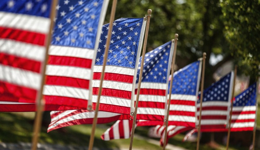 American flags flutters in the wind. Photo via CBS.