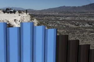 FILE - In this Jan. 25, 2017, file photo, an agent from the border patrol, observes near the Mexico-US border fence, on the Mexican side, separating the towns of Anapra, Mexico and Sunland Park, N.M. Photo via AP/Christian Torres.