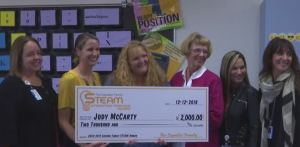 STEM teacher Jody McCarty receives a check with $2,000 in grant money on Wednesday, Dec. 12. Photo via WINK News.