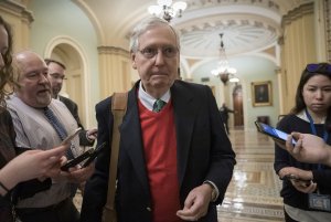 Senate Majority Leader Mitch McConnell, R-Ky., is met by reporters as he arrives at the Capitol on the first morning of a partial government shutdown in Washington, Saturday, Dec. 22, 2018. Photo via AP/Scott Applewhite.