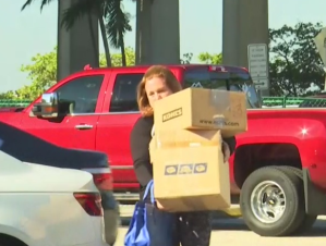 Carrie Ehrlich takes packages to the post office. Photo via WINK News.
