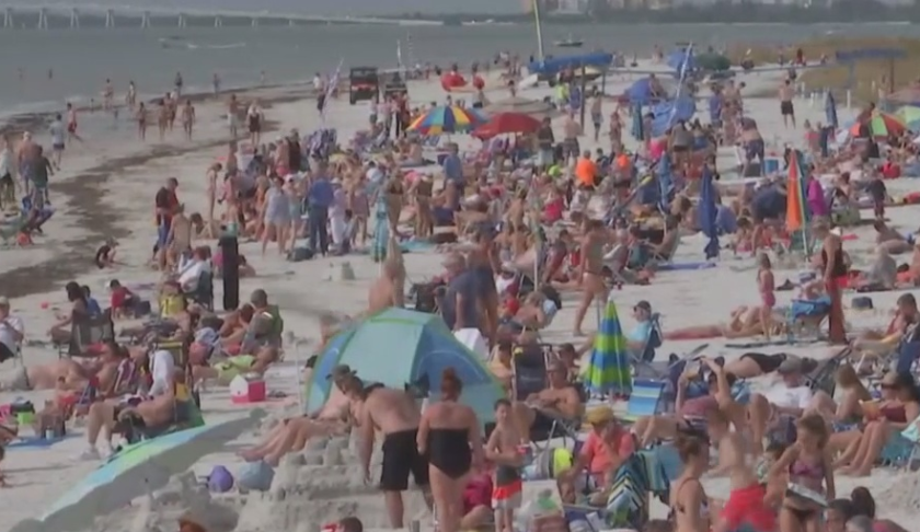 Beaches are packed to the delight of businesses. Photo via WINK News.