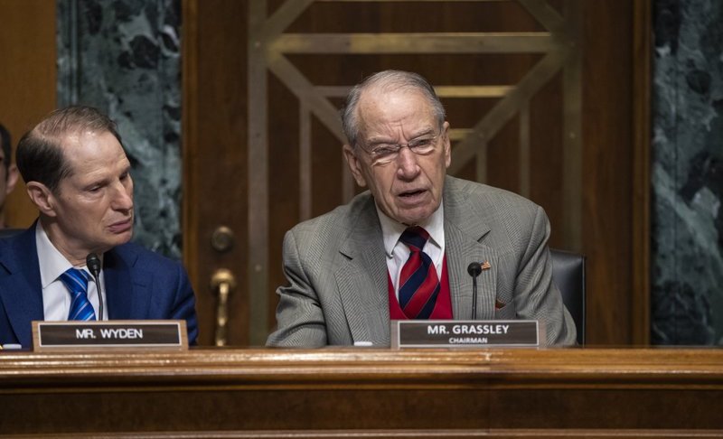 Sen. Chuck Grassley, R-Iowa, center, chairman of the Senate Finance Committee, is joined at left by Sen. Ron Wyden, D-Ore., the ranking member, at a hearing on the high price of prescription drugs, on Capitol Hill in Washington, Tuesday, Jan. 29, 2019. (AP Photo/J. Scott Applewhite)