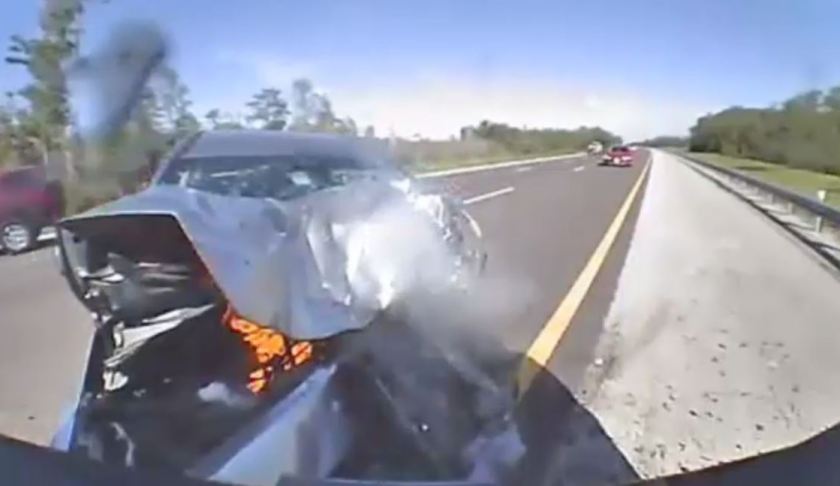 Fire inflames a Mazada after crashing into an FHP vehicle. Photo via FHP.