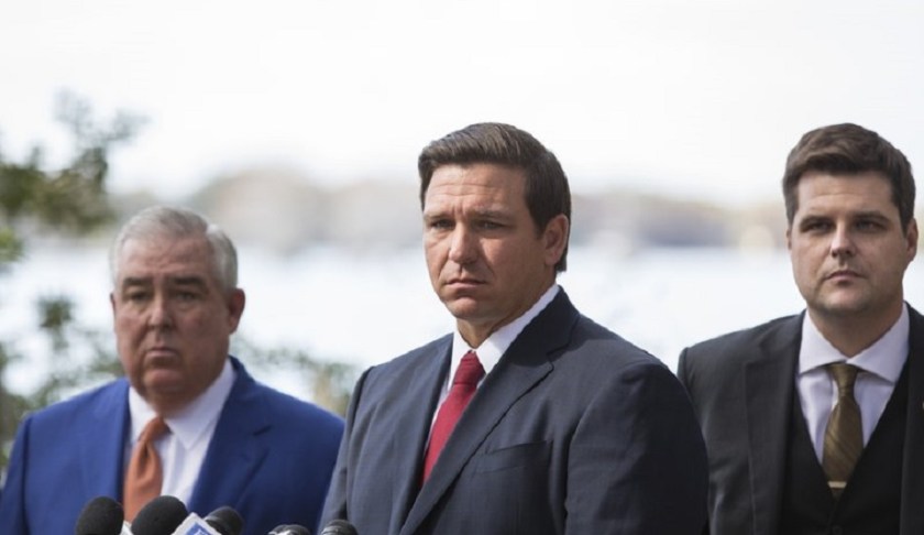 Governor Ron DeSantis, center, John Morgan, left, and U.S. Congressman Matt Gaetz, right, during a press conference to pressure state legislators and give them a mid-March deadline to repeal a law that prohibits smokable forms of medical marijuana at Kraft Azalea Garden in Winter Park, Fla., Thursday, Jan. 17, 2019. (Willie J. Allen Jr./Tampa Bay Times via AP)
