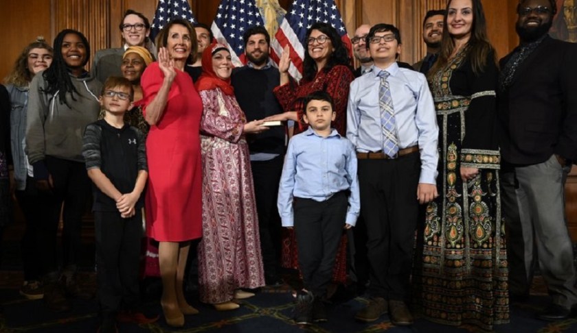 House Speaker Nancy Pelosi of Calif., poses during a ceremonial swearing-in with Rep. Rashida Tlaib, D-Mich., sixth from right, on Capitol Hill in Washington, Thursday, Jan. 3, 2019, during the opening session of the 116th Congress. Photo via AP/Susan Walsh.