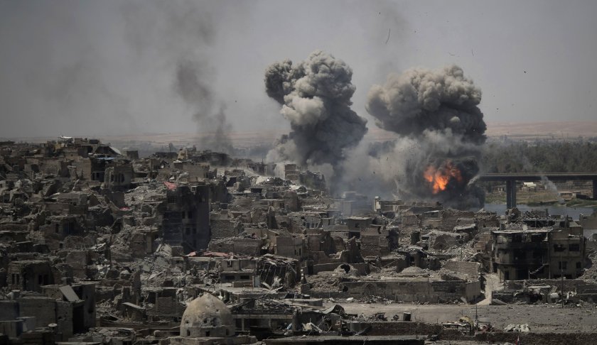 In this July 11, 2017 file photo, airstrikes target Islamic State group positions on the edge of the Old City, in Mosul, Iraq. Photo via AP/Felipe Dana, File.