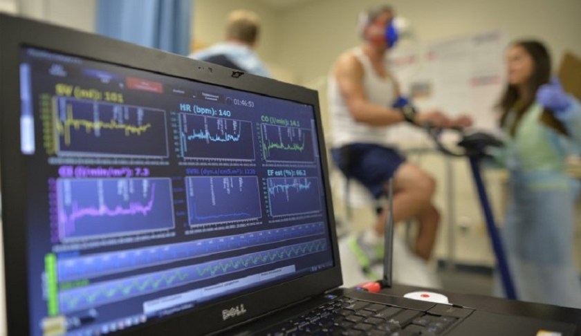 FILE - In this Aug. 27, 2014 file photo, a laptop computer monitors a patient's heart function as he takes a stress test while riding a stationary bike in Augusta, Ga. A report released on Wednesday, Jan. 30 2019 estimates that nearly half of all U.S. adults have some form of heart or blood vessel disease, a medical milestone that's mostly due to recent guidelines that expanded how many people have high blood pressure. (AP Photo/The Augusta Chronicle, Michael Holahan)