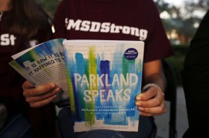 In this Wednesday, Jan. 16, 2019, photo, Leni Steinhardt, 16, reads from a new book called "Parkland Speaks: Survivors from Marjory Stoneman Douglas Share Their Stories," during an interview with The Associated Press, in Parkland, Fla. AP Photo/Brynn Anderson.