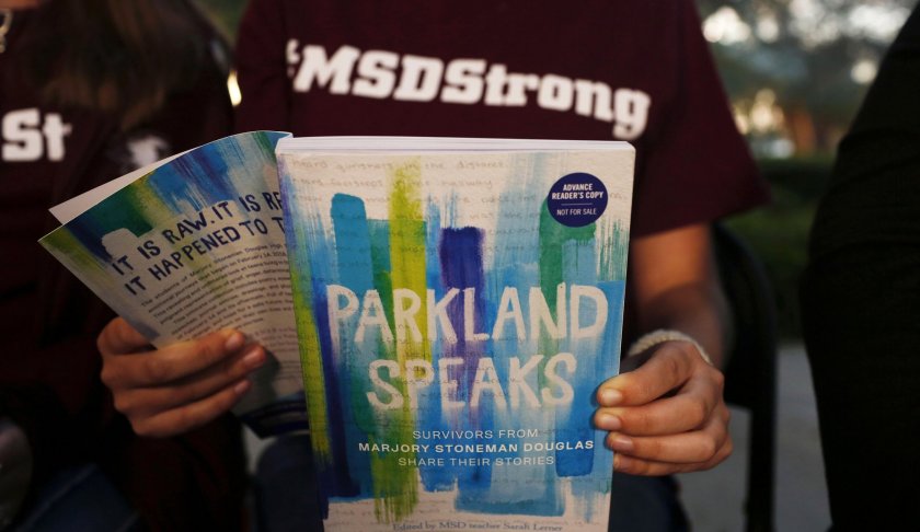 In this Wednesday, Jan. 16, 2019, photo, Leni Steinhardt, 16, reads from a new book called "Parkland Speaks: Survivors from Marjory Stoneman Douglas Share Their Stories," during an interview with The Associated Press, in Parkland, Fla. AP Photo/Brynn Anderson.