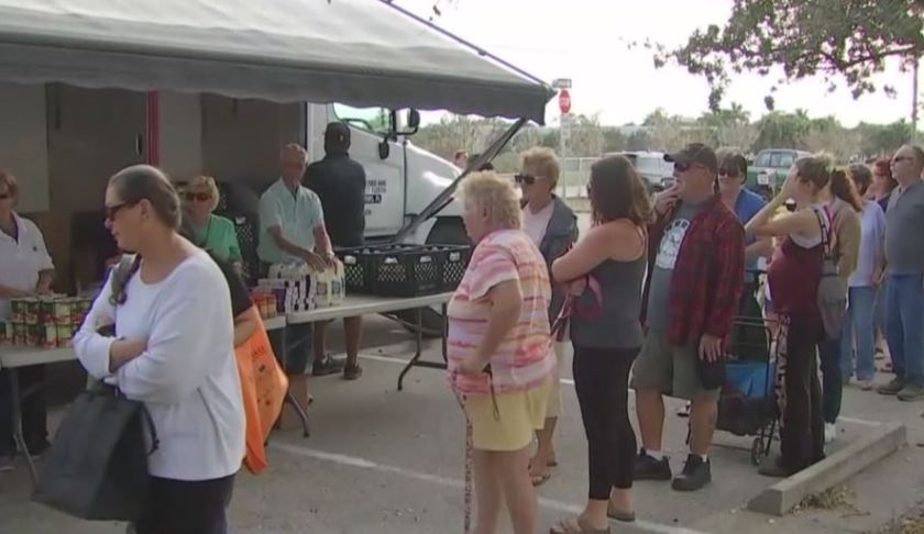 People inline for items at the Harry Chapin Food Bank. Photo via WINK News.