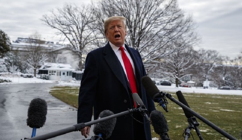 President Donald Trump talks with reporters on the South Lawn of the White House before departing for the American Farm Bureau Federation's 100th Annual Convention in New Orleans, Monday, Jan. 14, 2019, in Washington. Photo via AP/ Evan Vucci.