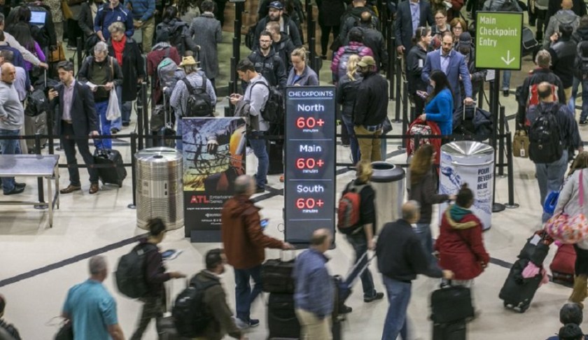 Security lines at Hartsfield-Jackson International Airport in Atlanta stretch more than an hour long amid the partial federal shutdown, causing some travelers to miss flights. Photo via AP.