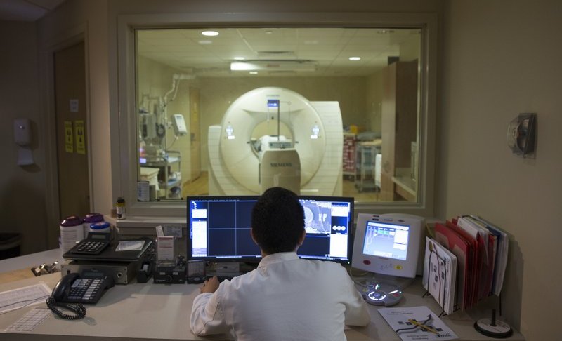 FILE - In this May 19, 2015 file photo, a nuclear medicine technologist makes a PET scan of a patient at Georgetown University Hospital in Washington. Depression has long been linked to certain cognitive problems, and now researchers at Yale University are using PET scans to study key brain connections and try to find out why. (AP Photo/Evan Vucci)
