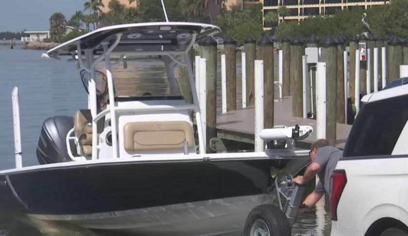 A vehicle pulls a boat. The method works as a temporary boat ramp. (WINK News photo)