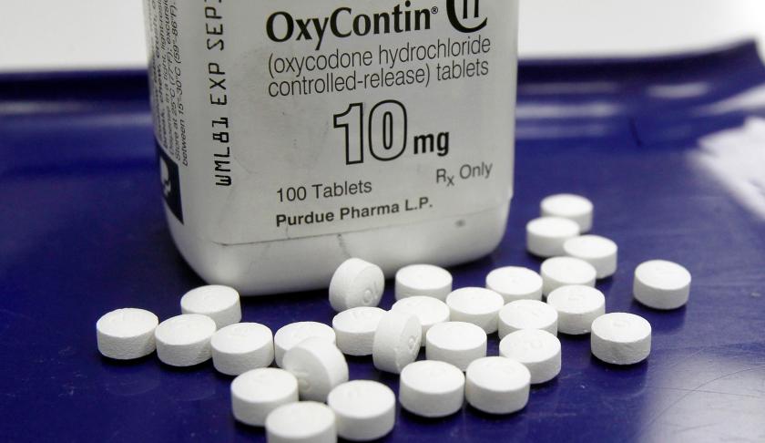 FILE - This Feb. 19, 2013, file photo shows OxyContin pills arranged for a photo at a pharmacy. (AP Photo/Toby Talbot, File)