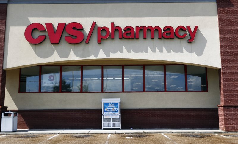 FILE- In this Aug. 7, 2018, file photo a CVS Pharmacy building sign rests on a Jackson, Miss., store. CVS Health topped fourth-quarter earnings forecasts, but the nation’s second-largest drugstore chain also debuted a 2019 outlook that fell far short of Wall Street expectations. The company said Wednesday, Feb. 20, 2019, that it expects adjusted earnings to range between $6.68 and $6.88 this year. FactSet says analysts expect earnings of $7.35 per share. (AP Photo/Rogelio V. Solis, File)