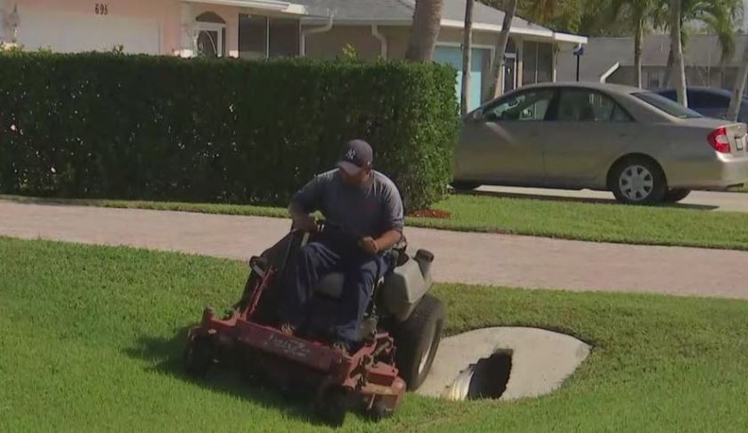 Gardner cuts the grass on the lawn. (WINK News photo)