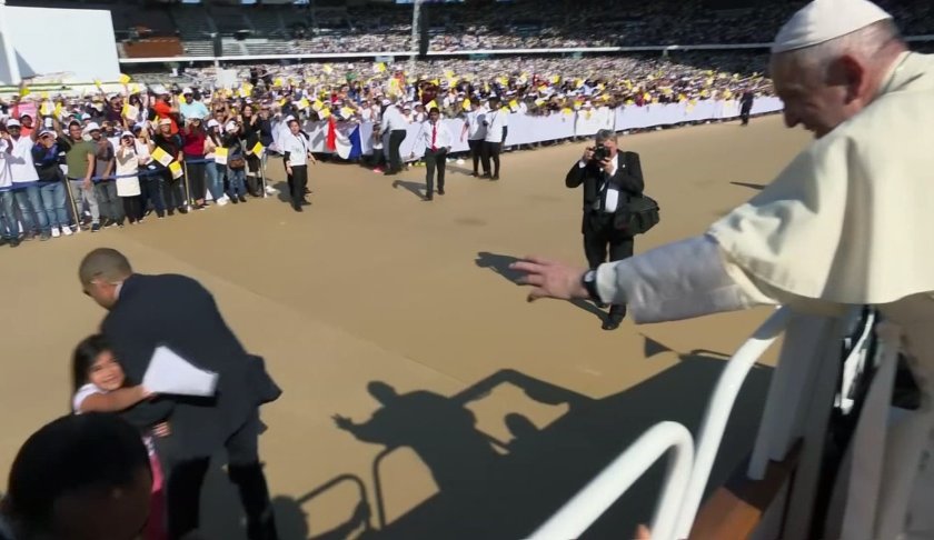 In this image made from video provided by Vatican Media, Pope Francis reaches for a letter from a young girl who broke through police barriers, in Abu Dhabi, United Arab Emirates, Tuesday, Feb. 5, 2019. Pope Francis has praised the courage of the young girl who dashed out of the crowd so quickly that police couldn't catch her. "This child has a future!" Francis told reporters en route home Tuesday. "I liked that. You have to have courage to do that." (Vatican Media via AP)