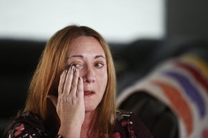 Lori Alhadeff, mother of 14-year-old Alyssa Alhadeff who was one of 17 people killed at Marjory Stoneman Douglas High School, wipes away a tear as she cries while talking about her daughter on Wednesday, Jan. 30, 2019, in Parkland, Fla. She and her husband marched with Parkland students in Washington, demanding gun control. And in May, she was elected to the school board. (AP Photo/Brynn Anderson)