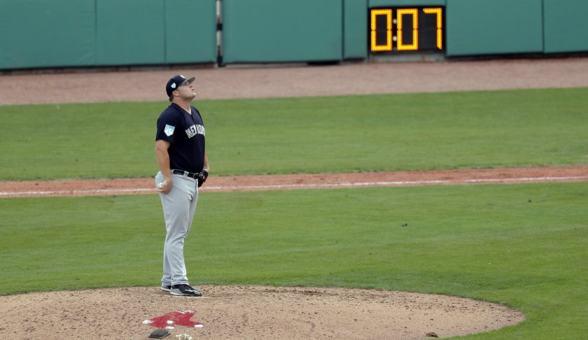 New York Yankees pitcher Cale Coshow prepares to pitch as the pitching clock winds down during a spring training baseball game against the Boston Red Sox in Fort Myers, Fla., Saturday, Feb. 23, 2019. (AP Photo/Gerald Herbert)