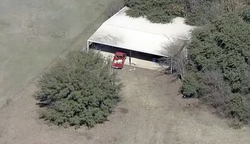 This aerial image provided by KDFW-FOX4 News shows part of the property where deputies found two young, malnourished children locked together in a dog cage near Rhome, Texas about 20 miles (32 kilometers) northwest of Fort Worth. A Texas sheriff says, Tuesday, Feb. 12, 2019, deputies responding to a domestic disturbance at a home discovered two young, malnourished children locked together in a dog cage while two others also were found malnourished. (AP Photo/KDFW-FOX4 News)