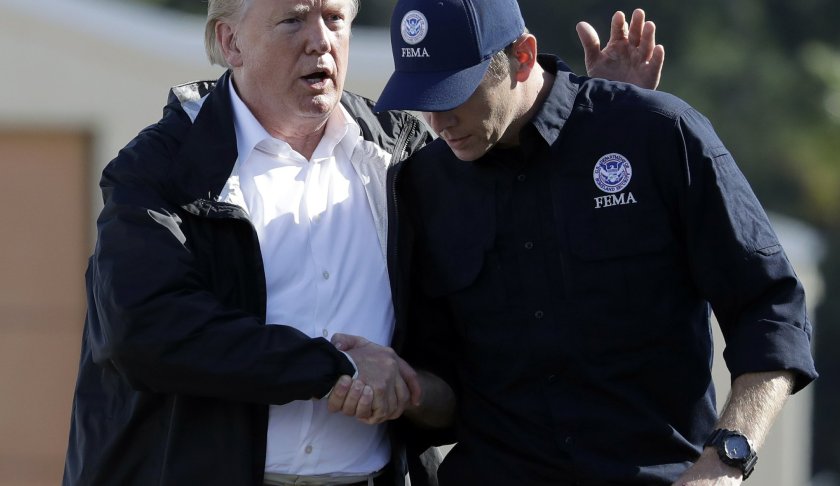 FILE - In this Sept. 19, 2018, file photo President Donald Trump shakes hands with FEMA Administrator Brock Long after visiting areas in North Carolina and South Carolina impacted by Hurricane Florence at Myrtle Beach International Airport in Myrtle Beach, S.C. Long has resigned from FEMA on Feb. 13, 2019. (AP Photo/Evan Vucci, File)