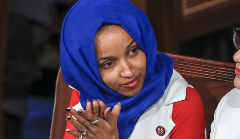 FILE - In this Feb. 5, 2019, file photo, Rep. Ilhan Omar, D-Minn., listens to President Donald Trump's State of the Union speech, at the Capitol in Washington. Omar "unequivocally" apologized Monday, Feb. 11, 2019, for tweets suggesting that members of Congress support Israel because they are being paid to do so, which drew bipartisan criticism and a rebuke from House Speaker Nancy Pelosi. (AP Photo/J. Scott Applewhite, File)