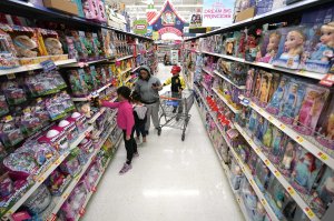 FILE- In this Nov. 9, 2018, file photo shoppers look at toys at a Walmart Supercenter in Houston. Walmart Inc. reports financial results Tuesday, Feb. 19, 2019. (AP Photo/David J. Phillip, File)