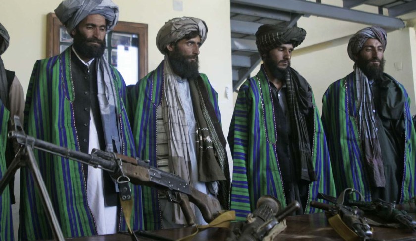 Former Taliban fighters hand over their weapons to Afghan police as part of a reconciliation process in Herat, Afghanistan, Sunday, May 13, 2012. (AP Photo/Hoshang Hashimi)