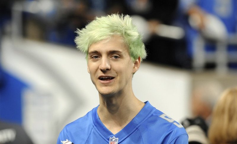 File-This Sept. 10, 2018, file photo shows Tyler "Ninja" Blevins before an NFL football game between the Detroit Lions and New York Jets in Detroit. For the first time since its meteoric rise, “Fortnite” is no longer a no-doubt victory royale atop the video game industry. “Apex Legends”, a battle royale from Electronic Arts, has stormed the market and smashed “Fortnite” records for downloads and viewership since its release three weeks ago. Blevins and other streaming stars have powered that surge, as has the emergence of an 18-year-old “Apex” superstar. Esports teams are already scrambling to sign talented players and invest long-term in the breakout title. (AP Photo/Jose Juarez, File)