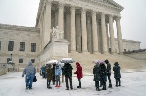 Visitors wait to enter the Supreme Court as a winter snow storm hits the nation's capital making roads perilous and closing most Federal offices and all major public school districts, on Capitol Hill in Washington, Wednesday, Feb. 20, 2019. The Supreme Court is ruling unanimously that the Constitution's ban on excessive fines applies to the states. The outcome Wednesday could help an Indiana man recover the $40,000 Land Rover police seized when they arrested him for selling about $400 worth of heroin. (AP Photo/J. Scott Applewhite)