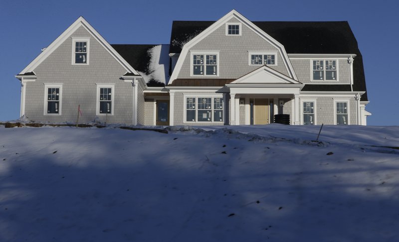 In this Thursday, Feb. 21, 2019 photo a recently constructed home is surrounded by snow in Natick, Mass. On Thursday, March 28, Freddie Mac reports on this week’s average U.S. mortgage rates. (AP Photo/Steven Senne)