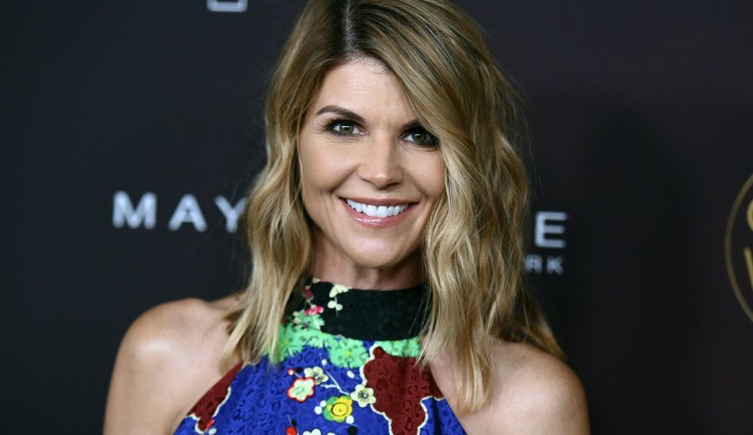 FILE - In this Oct. 4, 2017 file photo, actress Lori Loughlin arrives at the 5th annual People Magazine "Ones To Watch" party in Los Angeles. The FBI says Loughlin has been taken into custody in connection with a scheme in which wealthy parents paid bribes to get their children into top colleges. FBI spokeswoman Laura Eimiller says Loughlin was in custody Wednesday morning in Los Angeles. She is scheduled to appear in court there in the afternoon. (Photo by Richard Shotwell/Invision/AP, File)