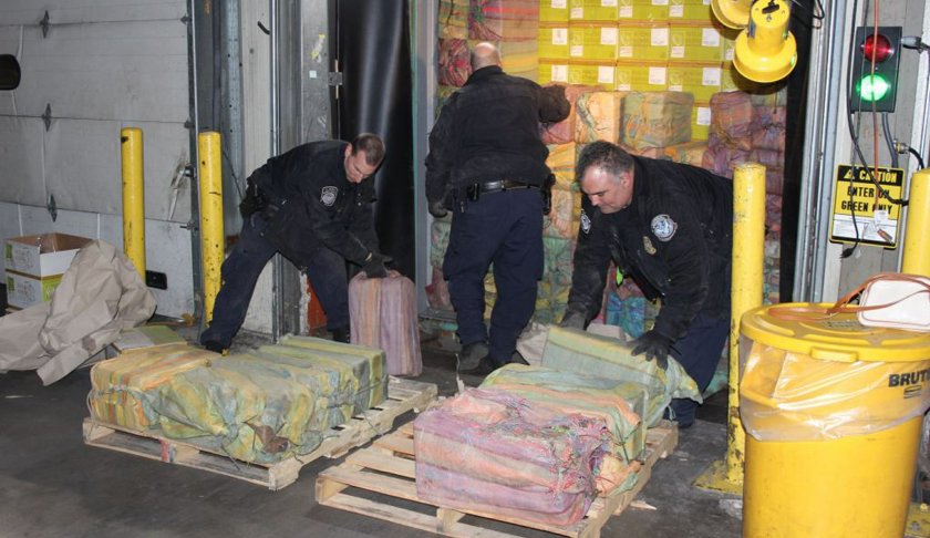 This Feb. 28, 2019 photo provided by U. S. Customs and Border Protection shows Customs agents unloading a truck containing 3,200 pounds of cocaine in 60 packages, where it was seized at the Port of New York/Newark, in Newark, N.J. A Customs spokesman says the container, recovered from a ship that originated in South America, held the biggest shipment of cocaine - with a street value estimated at about $77 million - recovered at the ports in 25 years. (U.S. Customs and Border Protection via AP)