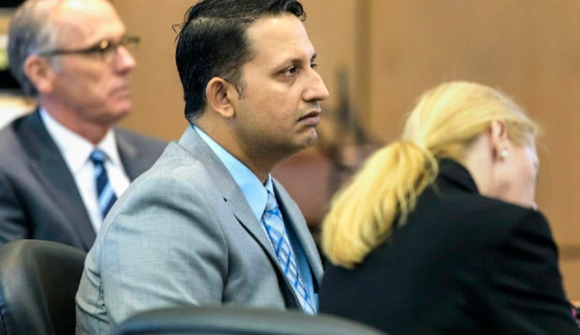 Nouman Raja sits between defense attorney Scott Richardson, left, and paralegal Debi Stratton as attorney Richard Lubin gives his closing arguments in Raja's trial, Wednesday, March 6, 2019 in West Palm Beach, Fla. Raja, a former Palm Beach Gardens police officer, is charged with the fatal 2015 shooting of stranded motorist Corey Jones. (Lannis Waters/Palm Beach Post via AP, Pool)
