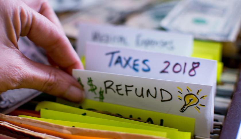 Person completing tax forms. (CBS News photo)