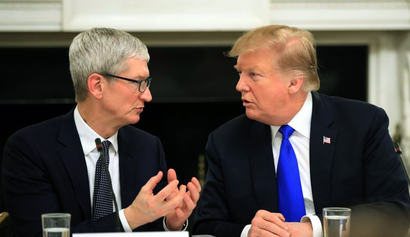 FILE - In this Wednesday, March 6, 2019 file photo, President Donald Trump talks to Apple Inc. CEO Tim Cook during the American Workforce Policy Advisory Board's first meeting in the State Dining Room of the White House in Washington. To President Donald Trump, it was an awkward slip of the lip. To Apple CEO Tim Cook, it was an opportunity to poke some lighthearted fun at a president who has often clashed with the tech industry. A day after Trump mistakenly referred to Cook at a Wednesday White House meeting as “Tim Apple” — an understandable slip, perhaps, coming from the head of the Trump Organization — Cook quietly changed his Twitter account, replacing his last name with the Apple logo. (AP Photo/Manuel Balce Ceneta, File)