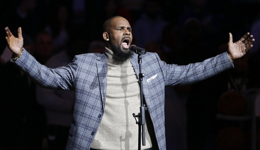 FILE - In this Nov. 17, 2015, file photo, musical artist R. Kelly performs the national anthem before an NBA basketball game between the Brooklyn Nets and the Atlanta Hawks in New York. Sex videos like those that have been integral to the criminal cases against R. Kelly have been circulating across the nation for years. Some of the tapes leaked out of the singer's collection in the 1990s. (AP Photo/Frank Franklin II, File)