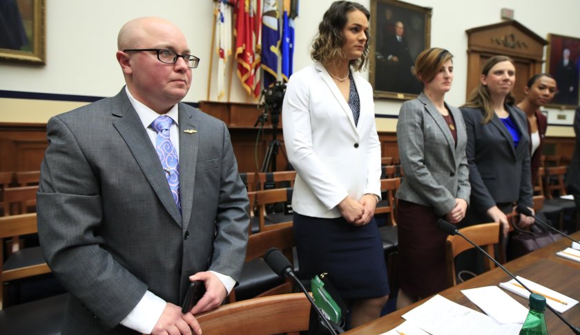 FILE - In this Feb. 27, 2019, file photo, from left, transgender military members Navy Lt. Cmdr. Blake Dremann, Army Capt. Alivia Stehlik, Army Capt. Jennifer Peace, Army Staff Sgt. Patricia King and Navy Petty Officer Third Class Akira Wyatt, listen before the start of a House Armed Services Subcommittee on Military Personnel hearing on Capitol Hill in Washington. The Defense Department has approved a new policy that will largely bar transgender troops and military recruits from transitioning to another sex, and require most individuals to serve in their birth gender. (AP Photo/Manuel Balce Ceneta, File)