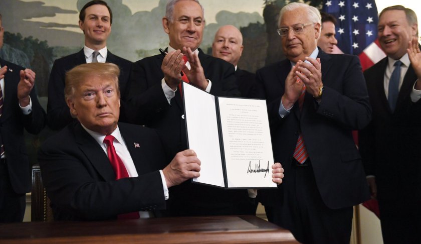 President Donald Trump holds up a signed proclamation recognizing Israel's sovereignty over the Golan Heights, as Israeli Prime Minister Benjamin Netanyahu looks on in the Diplomatic Reception Room of the White House in Washington, Monday, March 25, 2019. (AP Photo/Susan Walsh)