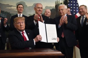 President Donald Trump holds up a signed proclamation recognizing Israel's sovereignty over the Golan Heights, as Israeli Prime Minister Benjamin Netanyahu looks on in the Diplomatic Reception Room of the White House in Washington, Monday, March 25, 2019. (AP Photo/Susan Walsh)